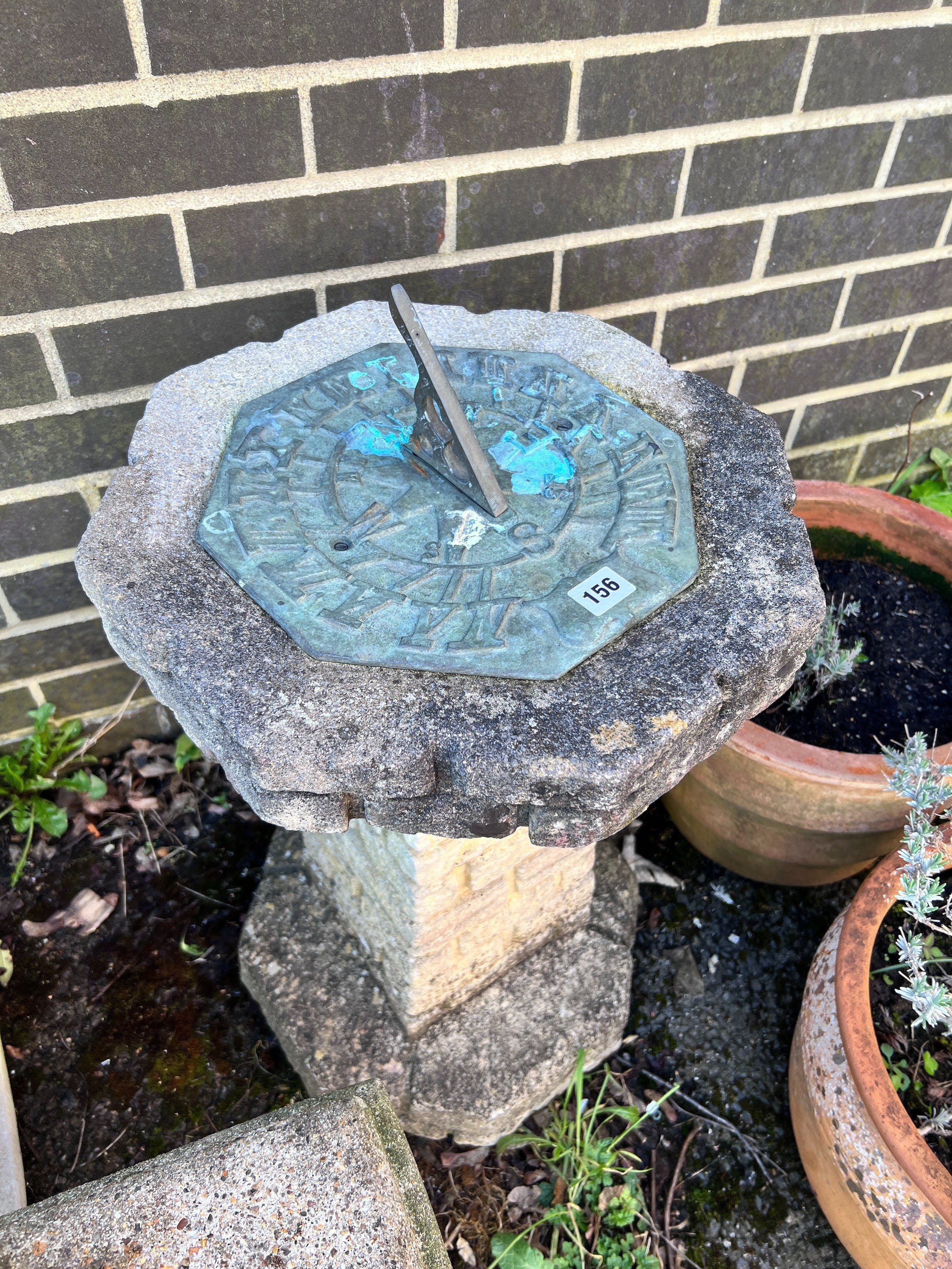 An octagonal reconstituted stone sundial on brick effect pillar, height 75cm *Please note the sale commences at 9am.